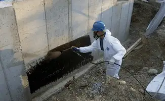 Professional waterproofing the exterior walls of the basement in Colorado Springs, CO