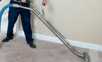 Professional operating a liquid removal machine on a carpeted floor in Colorado Springs, CO